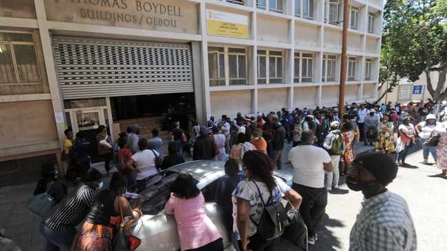 Hundreds of people queue outside the Labour Department building in the Cape Town CBD on Friday to claim their UIF grants