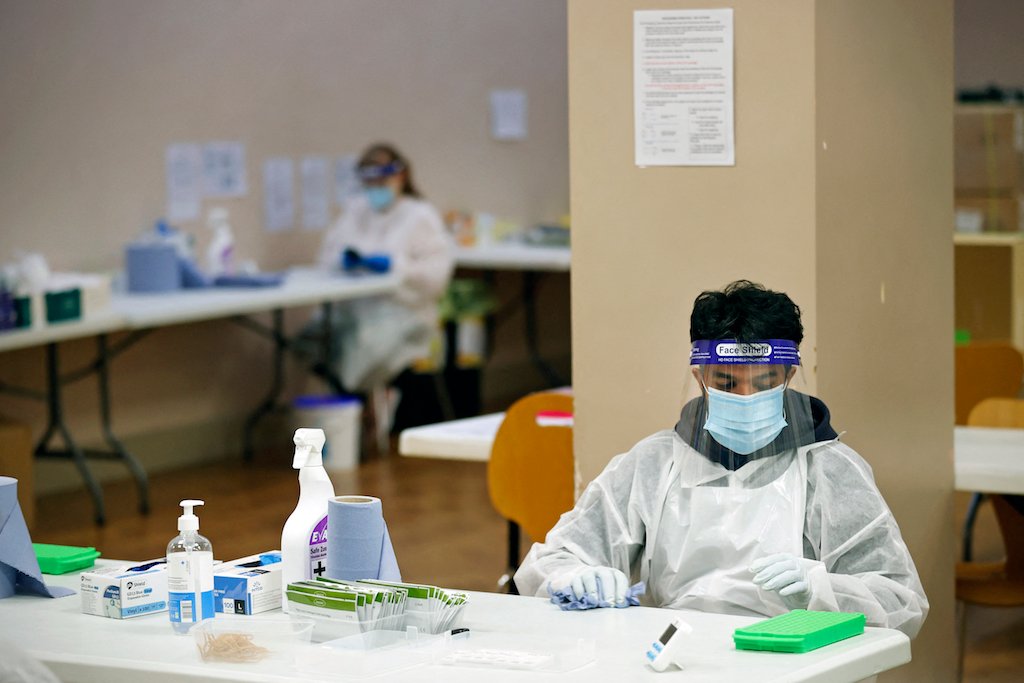 A health worker processes COVID-19 lateral flow tests