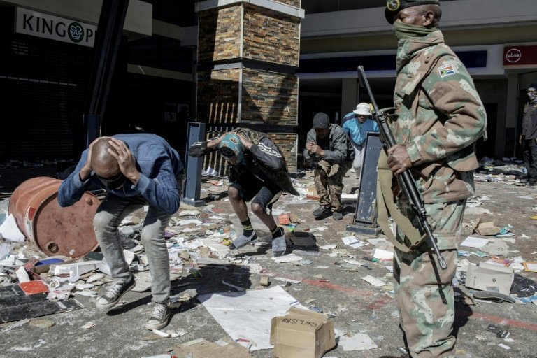 Police and troops detaining suspected looters at the Jabulani shopping mall in Soweto