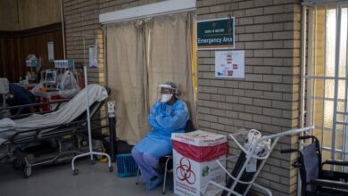 COVID-19 coronavirus healthcare worker looks at the hall where people are getting vaccinated at the Bertha Gxowa Hospital in Germiston