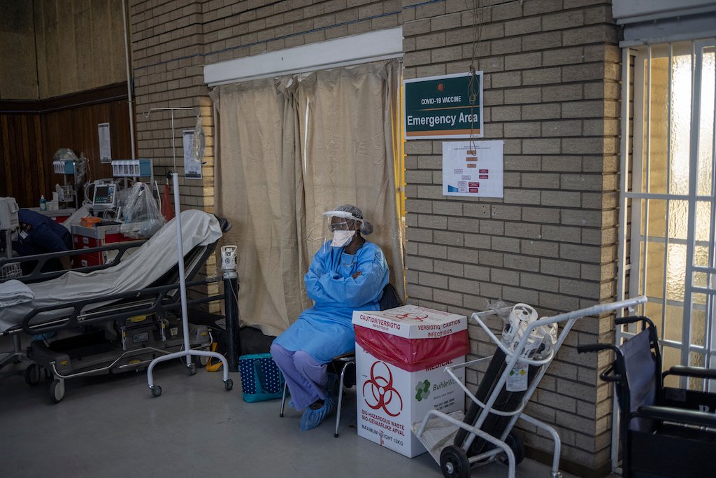 COVID-19 coronavirus healthcare worker looks at the hall where people are getting vaccinated at the Bertha Gxowa Hospital in Germiston