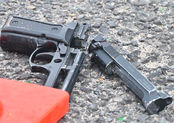 The wounded suspect who tried to shoot a traffic officer was taken to hospital after he was shot in the leg