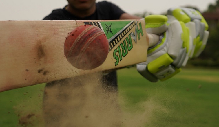 Player hits a cricket ball
