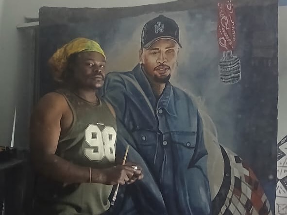 Rasta shows off his Chris Brown painting